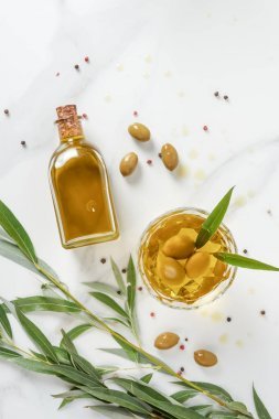 大理石桌上有橄欖油的瓶子和玻璃的頂部視圖