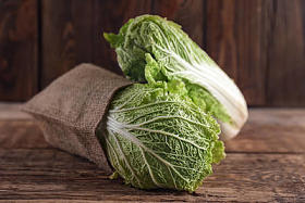 木桌上有新鲜熟卷心菜的麻袋图片