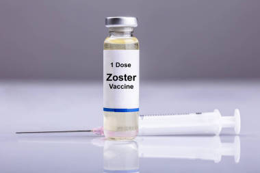 帶注射器的帶狀皰疹疫苗瓶在反光背景下