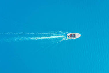 顶视图的白船在蔚蓝的大海中航