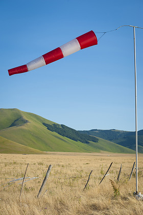 红色和白色的风向袋吹对蔚蓝的天空。同一性 di 阿西西意大利