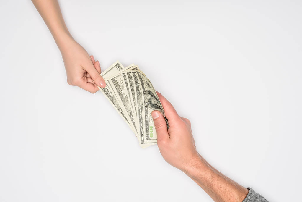 裁剪视图的夫妇分享钱隔离在灰色