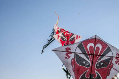 一排排中國(guó)紙風(fēng)箏在晴朗的藍(lán)天上飛翔