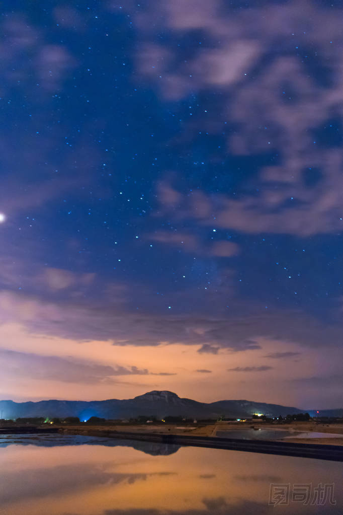 星空映照在水面上, 山頂上有一些云