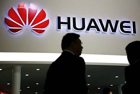 File - A visitor at a Huawei booth in Beijing, China, Oct. 12, 2010