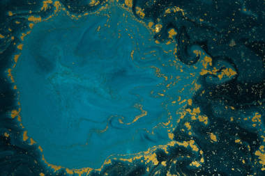 抽象藍(lán)色油漆背景與金黃閃光粉末 