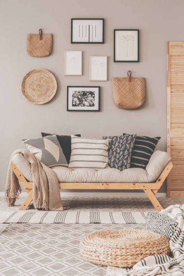 斯堪的納維亞客廳米色墻壁上的黑白海報(bào)和柳條配件畫(huà)廊