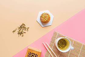 平铺中秋节甜点，中秋节月饼，背景五彩斑斓，绿茶和筷子。 顶部视图、复制空间、模型、头顶、模板