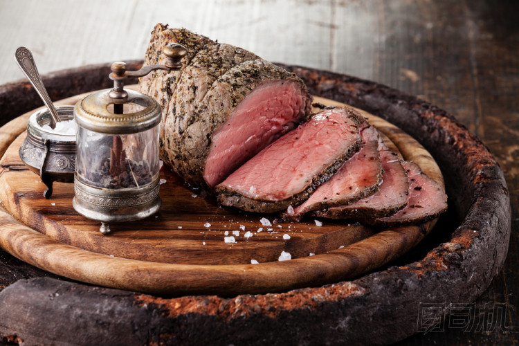 烤牛肉上鹽與胡椒磨切菜板圖片