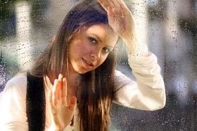 雨后窗户附近的年轻女子图片