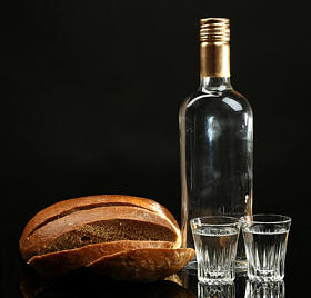 瓶伏特加，新鲜的面包和孤立的黑色的眼镜