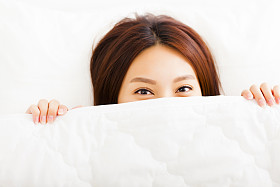 年轻微笑的女人，在床上图片