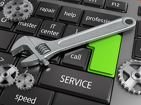 Electronic technology support concept - wrench on computer keyboard