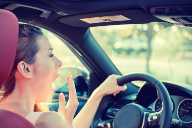 累了、 疲憊、 精疲力竭的年輕漂亮的女性駕駛她的車