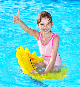 孩子在充气环大拇指上坐.照片