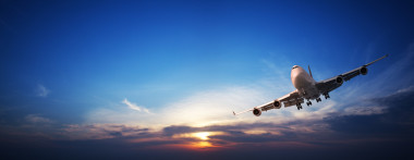 jet 巡航在落日的天空。全景圖像