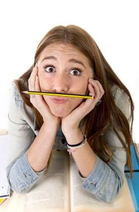 The beautiful young student held the pen between the nose and lips as a memorandum of understanding