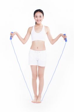 跳绳,白色背景的年轻女孩 跳绳,白色背景的年轻女孩