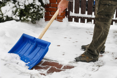 在暴風(fēng)雪后從人行道上除雪的人