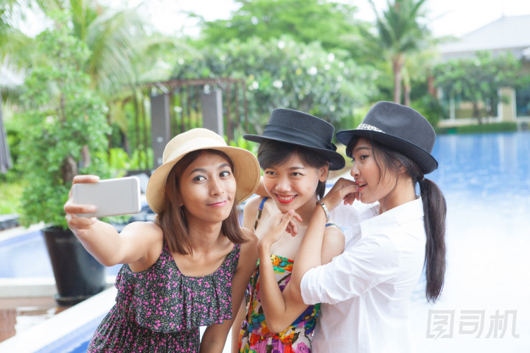 通過智能手機(jī)的年輕亞裔女子拍照肖像使用