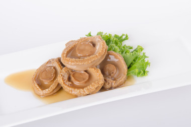 鮑魚(yú)。中國(guó)菜鮑魚(yú)背景上.圖片