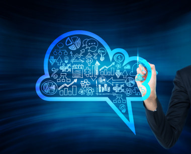 A woman's hand is drawing a cloud with business icons on the glass screen. A concept of new digital business opportuniti