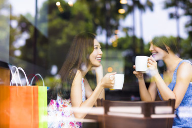 兩個年輕女子在一家咖啡館聊天
