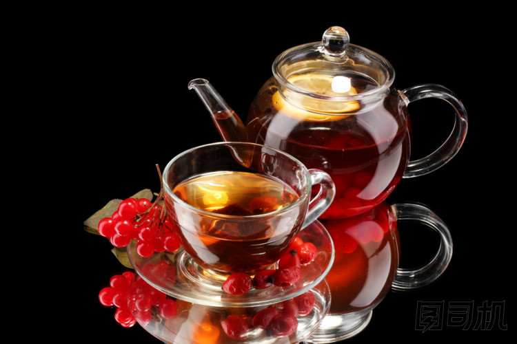 玻璃茶壺和杯子與孤立在黑色的黑瓊花茶