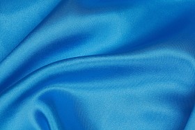 蓝色的丝绸布的波浪抽象背景照片