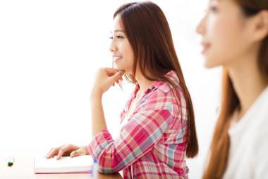 微笑的青年学生，与其他人在教室