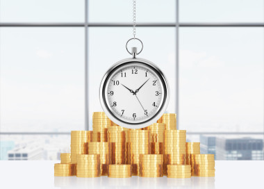 A composition of golden coins and hanging on the chain pocket watch. New York panoramic office on background. A concept 