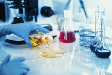 Science, chemistry, technology, biology, human concepts -- young female scientists mix reagents from inside glass flasks and test or study them in clinical laboratories