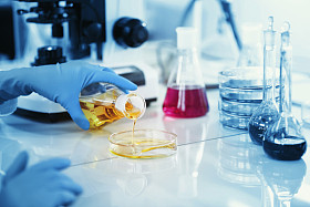 Science, chemistry, technology, biology, human concepts -- young female scientists mix reagents from inside glass flasks and test or study them in clinical laboratories