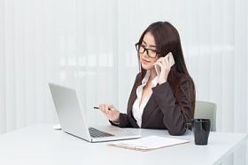 办公室在便携式计算机上工作的商界女强人