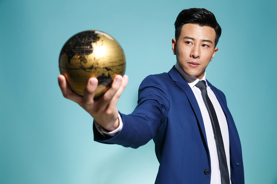 青年商务男人拿着地球仪图片