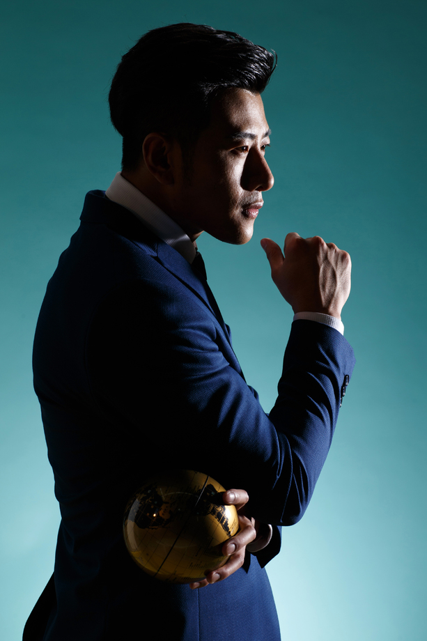 青年商务男人拿着地球仪图片