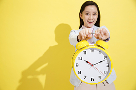 青年商务女士拿着钟表