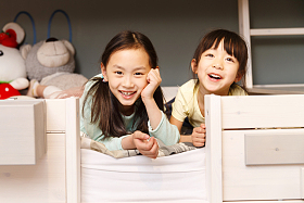 可爱的小女孩在床上玩耍