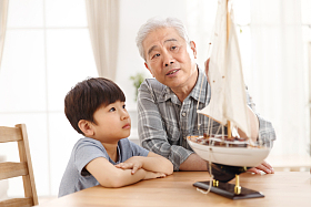 祖父和孙子在客厅玩耍照片