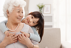 可爱的小女孩和祖母在客厅照片