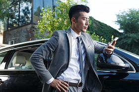 青年男人站在汽车旁边