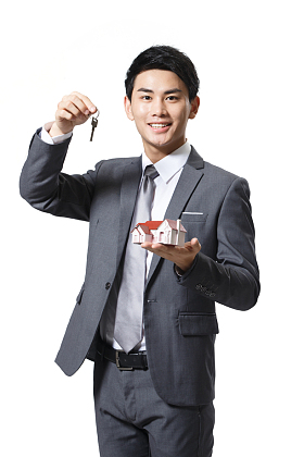 商务男人拿着房屋模型图片