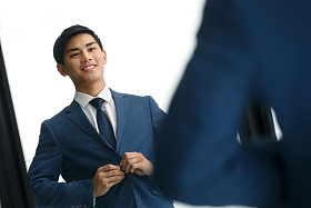 商务青年男人在镜子前穿衣服