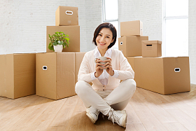 青年女人坐在地板上喝水照片