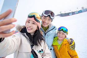 滑雪场上一家三口搂在一起自拍