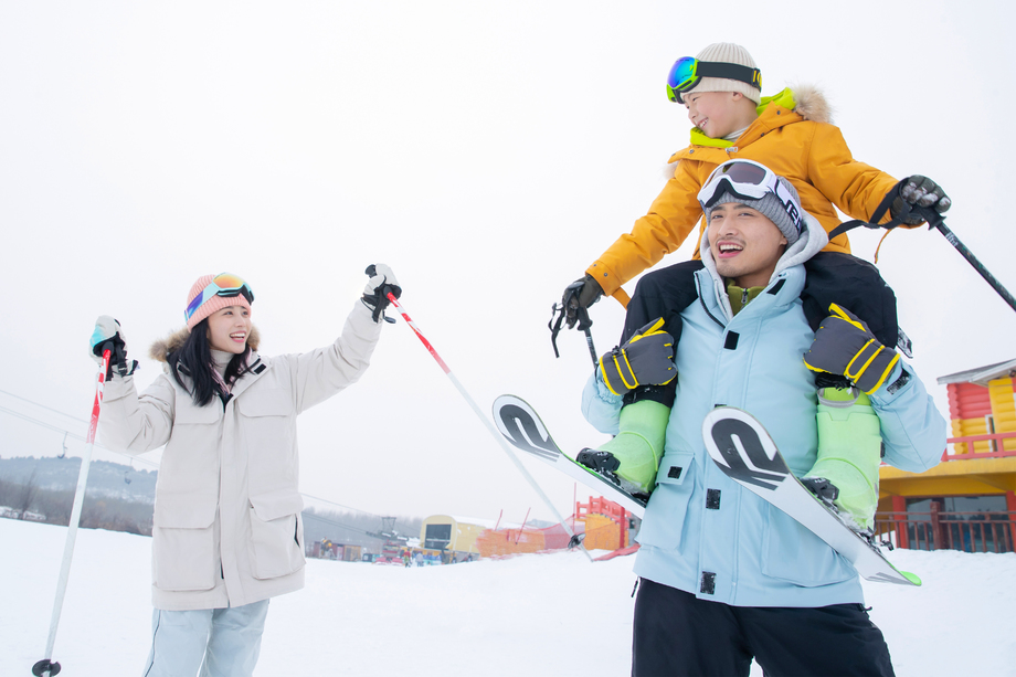 滑雪场内边滑雪边玩耍的三口之家 滑雪场内边滑雪边玩耍的三口之家