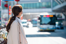 青年女人戴口罩在户外行走
