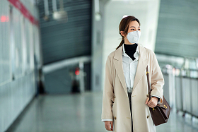 戴口罩的年轻女人走在地铁站