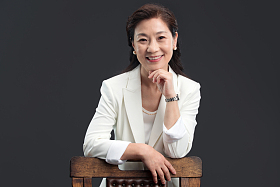 手搭在椅背上的优雅商务女士图片