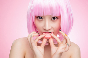 吃马卡龙的时尚年轻女孩图片